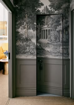 an open door leading into a room with a mural on the wall