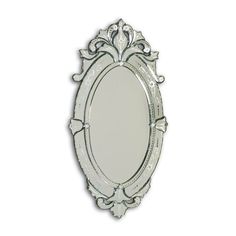 a white oval mirror with an ornate frame