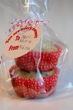 some red and white cupcakes wrapped in plastic