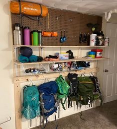 there are many backpacks hanging on the wall in this small room, and it's easy to use