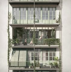 an apartment building with plants growing on the balconies