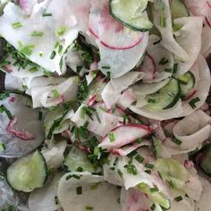 cucumber and radish salad with herbs on top, ready to be eaten