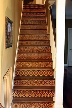 the stairs are made out of wood and have intricate designs on them