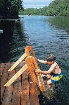 a young boy is playing on the dock