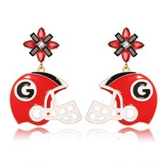 a pair of red and black earrings with the letter g on it's face