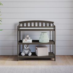 a teddy bear sitting next to a shelf