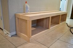 a wooden shelf sitting on top of a tiled floor