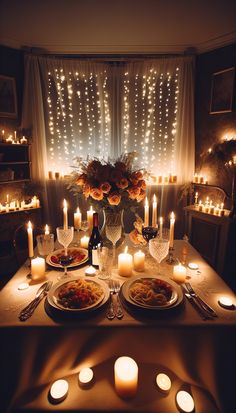 a dinner table with candles and food on it in front of a window filled with lights