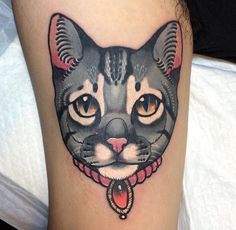 a black and white cat tattoo on the leg