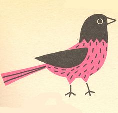 a pink and black bird sitting on top of a piece of paper