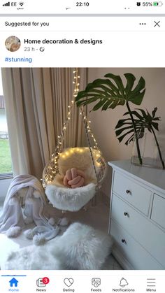 a white hammock hanging from a ceiling in a bedroom next to a potted plant