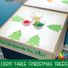 a light table with christmas trees on it and candy in bowls next to the words can you decorate the tree?