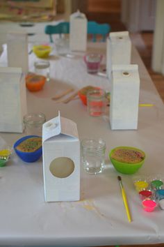 the table is set up with all kinds of crafting supplies for kids to make