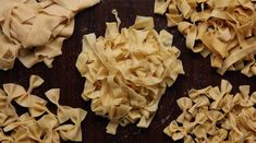 several different types of pasta on a wooden surface