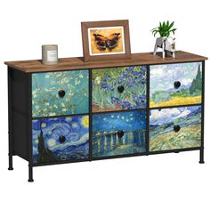 an artistic dresser with paintings on the drawers