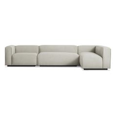 a white sectional couch sitting on top of a white floor