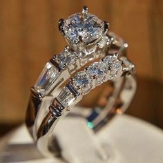 two wedding rings sitting on top of each other