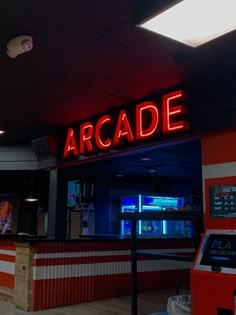 the arcade sign is lit up at night