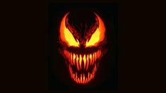 a pumpkin with an evil face on it's face and glowing orange flames in the background