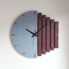 a wall clock made out of wood and metal