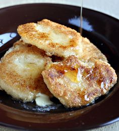 some fried food on a brown plate with a toothpick sticking out of it