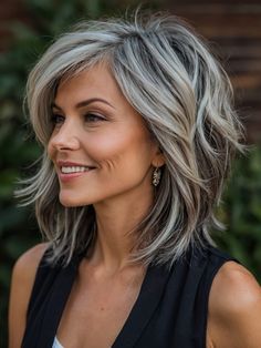 I’m eager to style a layered long shag for the trendsetter over 50. This hairstyle is all about flowing layers that offer movement and an airy feel, making it a fantastic choice for someone who always wants to stay ahead of fashion trends. Envision this look in luxurious brunette or icy silver tones, suitable for fashion shows, upscale shopping days, or cultural events. Her stylish, forward-thinking wardrobe matches her innovative hairstyle, while her engaging smile shows she’s comfortable in the spotlight. Haircut And Color, Medium Length Hair Cuts, Grey Hair, Great Hair