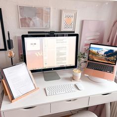 a desk with a laptop, monitor and keyboard on it