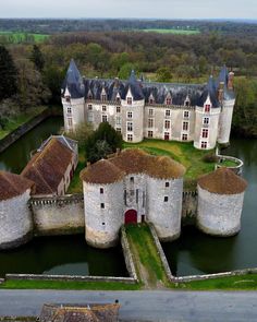 an aerial view of a castle in the middle of a lake