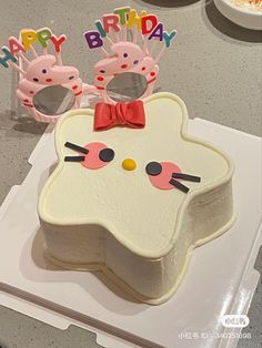 a birthday cake decorated with hello kitty glasses