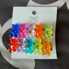 a bunch of colorful gummy bears sitting on top of a white card with a bow