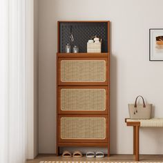 a wooden cabinet with baskets on it next to a white wall and a beige rug