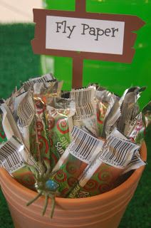 a pot filled with candy sitting on top of a grass covered field next to a sign