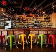 colorful bar stools in front of the bar