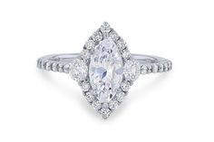 a pear shaped diamond engagement ring on a white background