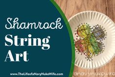 a paper plate with string art on it and the words, shamrock string art written in white