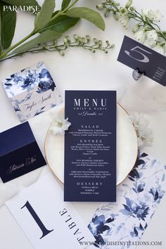 a table topped with flowers and menu cards