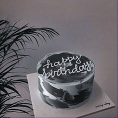 a black and white photo of a birthday cake with the words happy birthday written on it