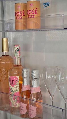 several bottles and glasses are sitting on the shelf