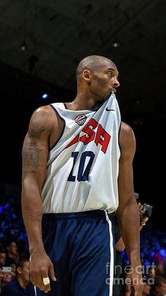 a basketball player holding a ball in his hand