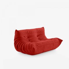 a red chair sitting on top of a white floor