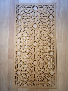 an intricately carved wooden panel on the floor