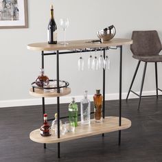 three tiered wooden bar cart with wine glasses and liquor bottles on the top shelf