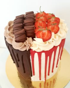 two cakes with strawberries and chocolate on top