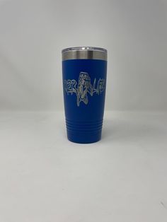 a blue tumbler cup sitting on top of a white table