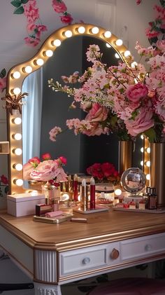 a vanity with flowers and lights on it