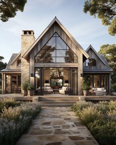 a large house with lots of windows and stone walkway leading up to the front door