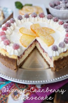 an orange cranberry cheesecake is cut into slices and served on a platter