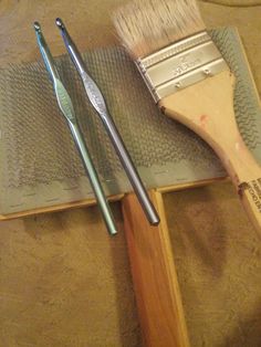 two brushes sitting on top of a wooden tray