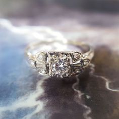 a diamond ring sitting on top of a table