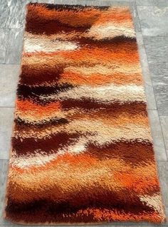 an orange and brown area rug on the floor